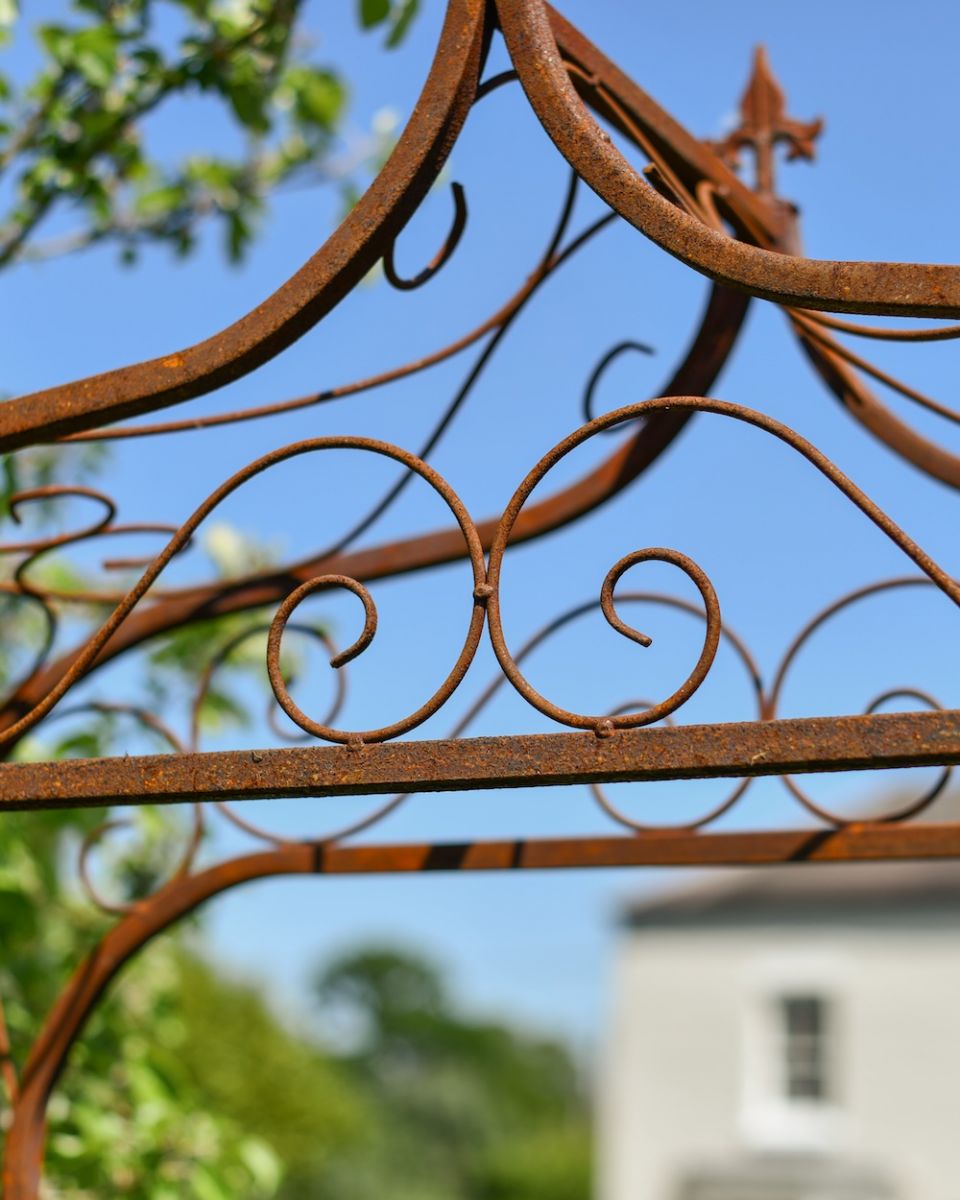 Close up of intricate scrollwork on rustic garden arch Close up of intricate scrollwork on rustic garden arch