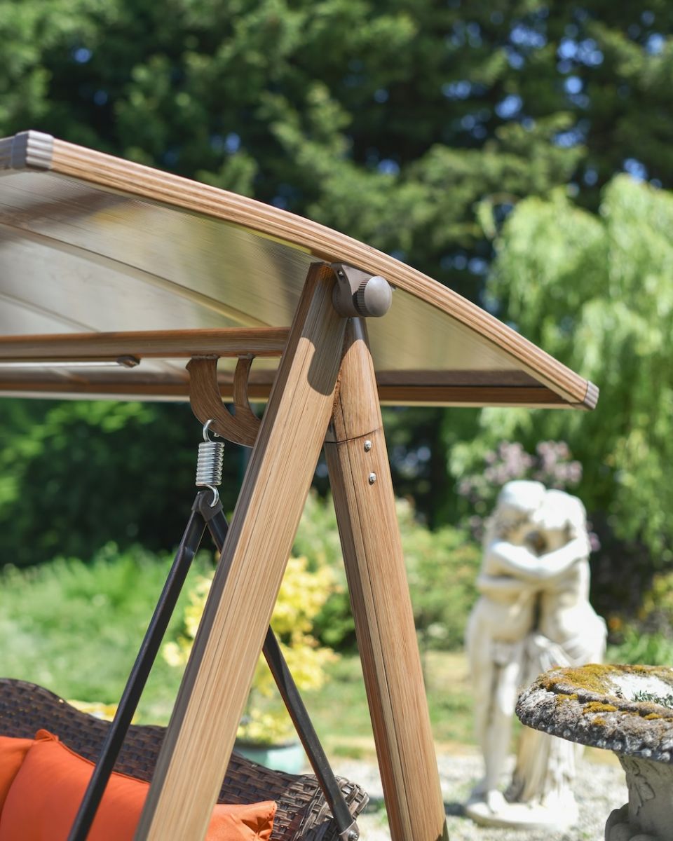 Close up of moveable shaded roof detail on patio swing seat Close up of moveable shaded roof detail on patio swing seat