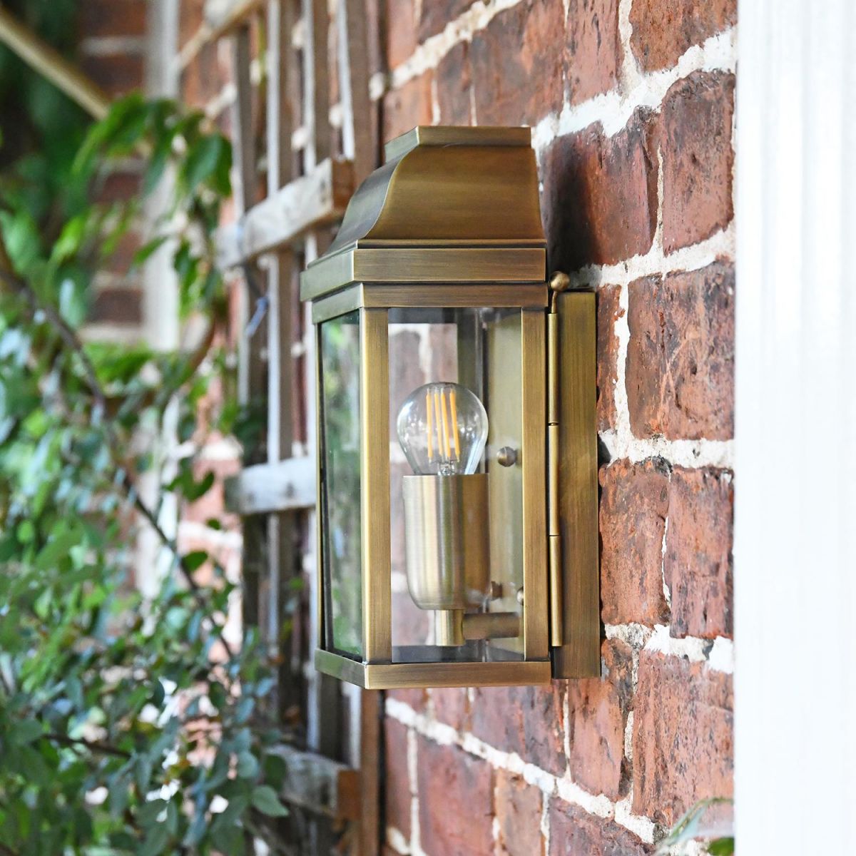 View of the Side of the Antique Brass Wall Lantern Flush against the Wall