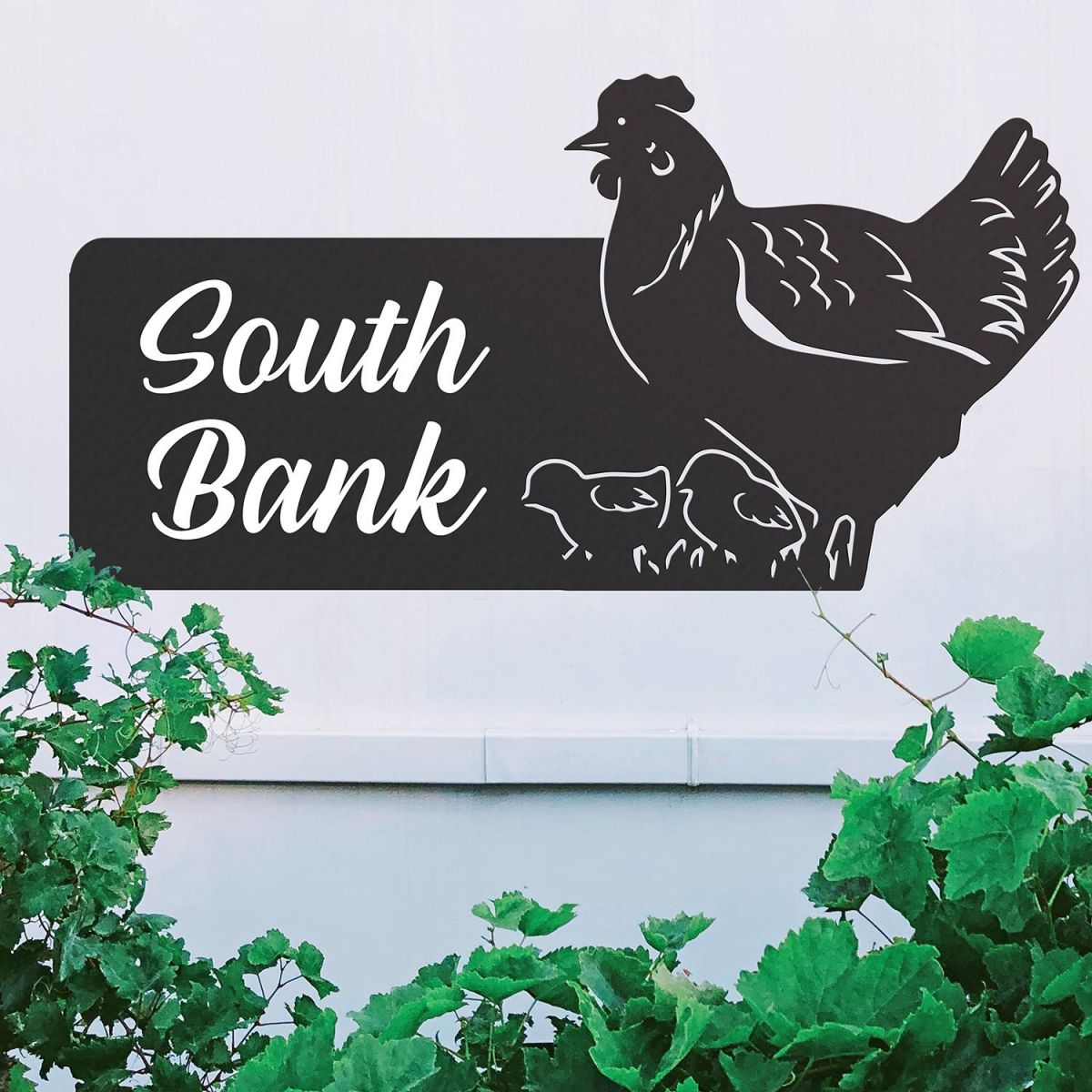 Black Hen & Chicks Iron House Name Sign on a White Wall