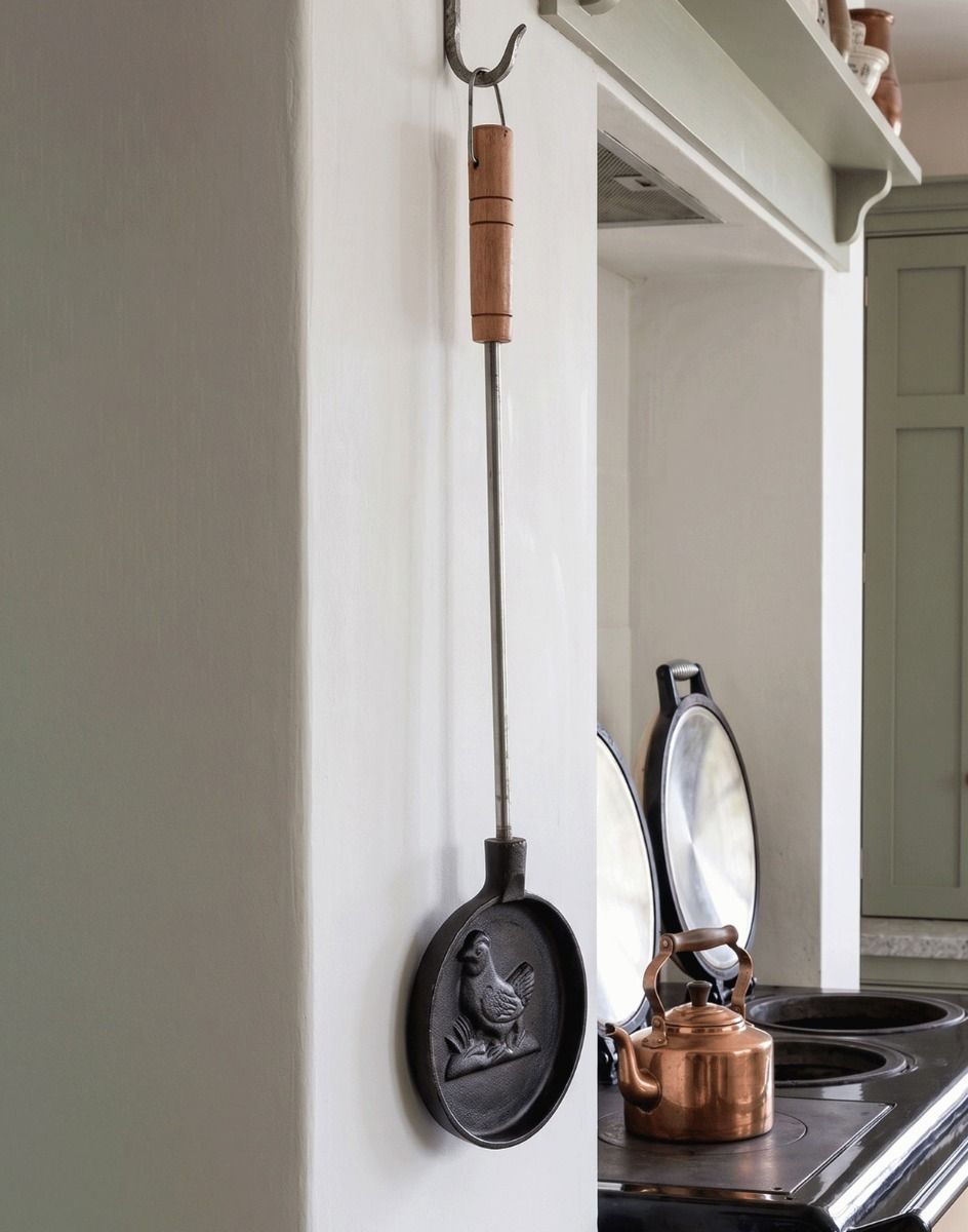 Hen Design Cookware Utensil Hung up in a Kitchen next to a Traditional Aga - Digital Illustration