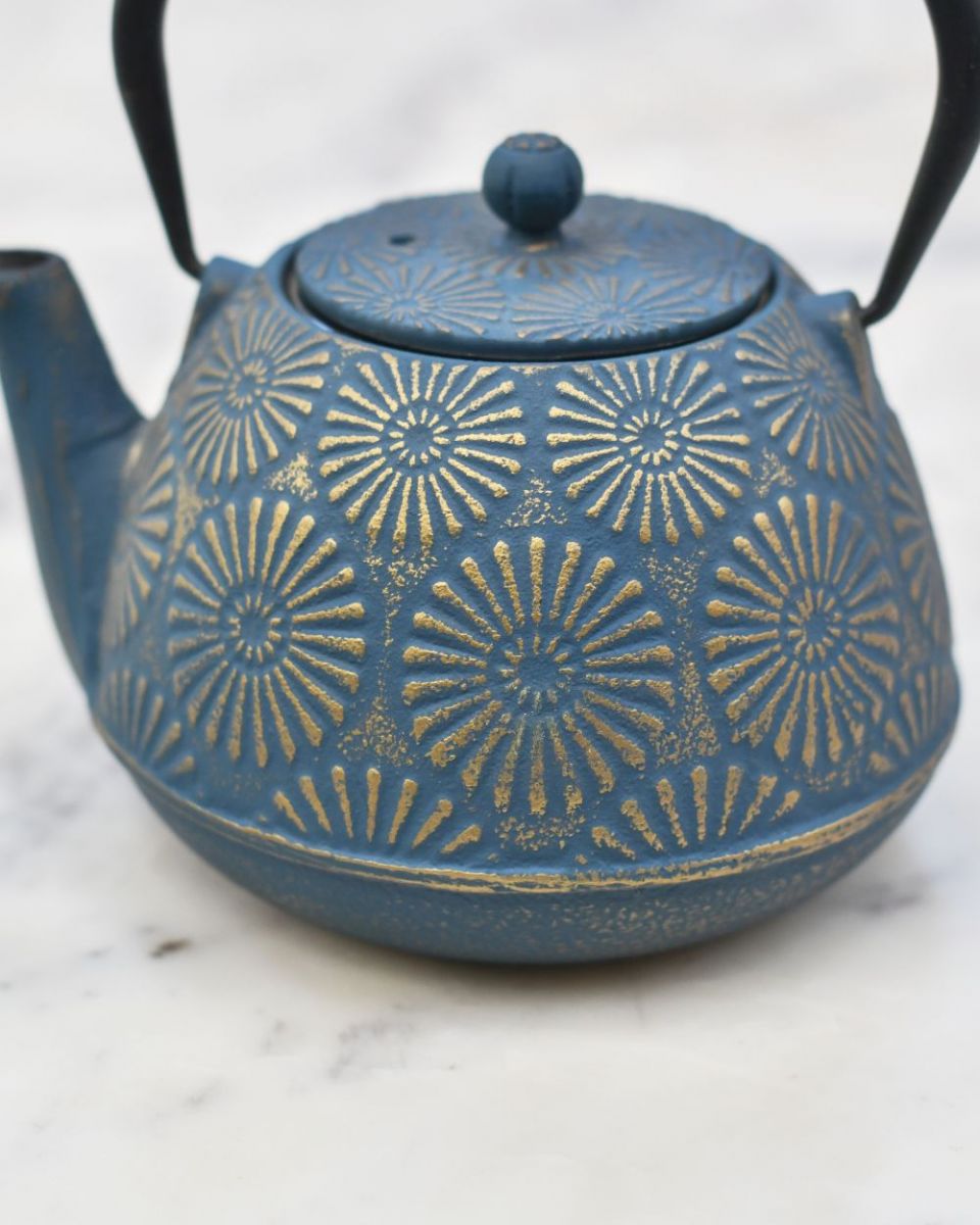 Close up of embossed sunflower detailing on "Himawari" Blue and Gold Cast Iron Japanese Style Teapot  Close up of embossed sunflower detailing on "Himawari" Blue and Gold Cast Iron Japanese Style Teapot