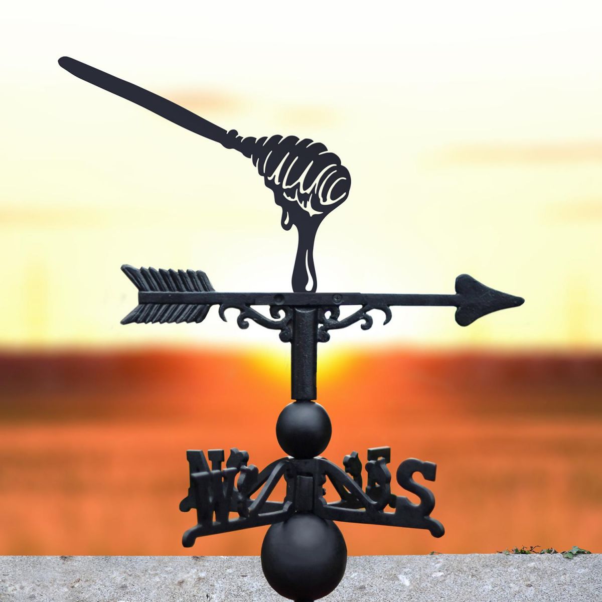 Honey Spoon Weathervane with the Sunset in the Background