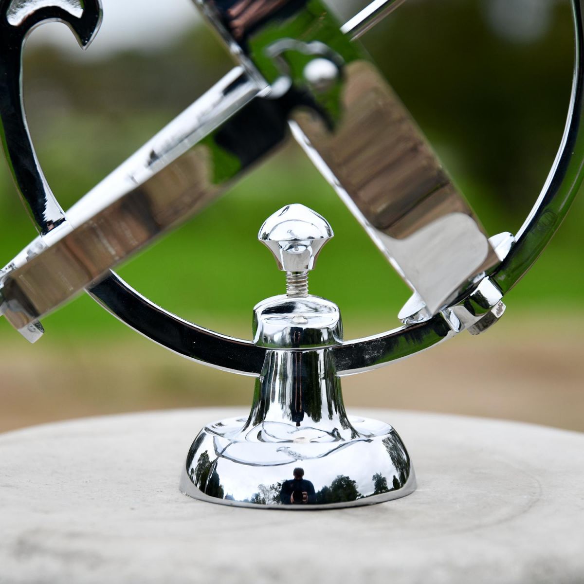 Close up of Bright Chrome Armillary Base