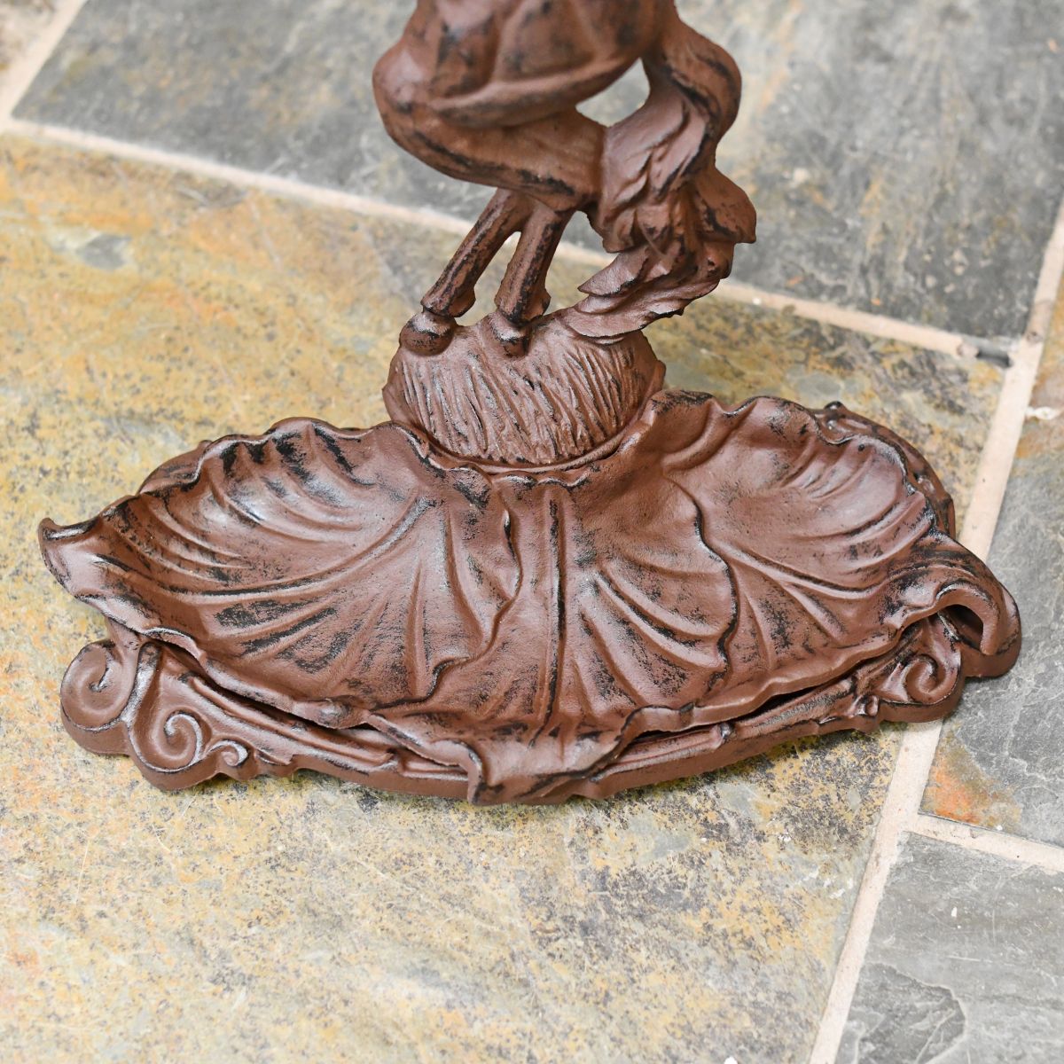 Detailed image of cast iron drip tray on entrance hall umbrella stand
