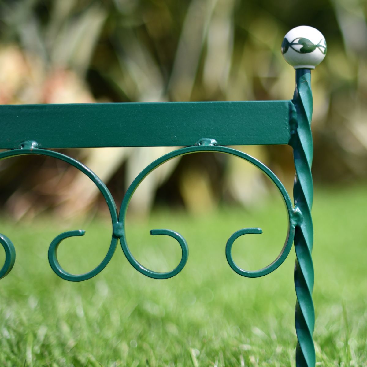 Close up of scrolled hand crafted racing green boot scraper