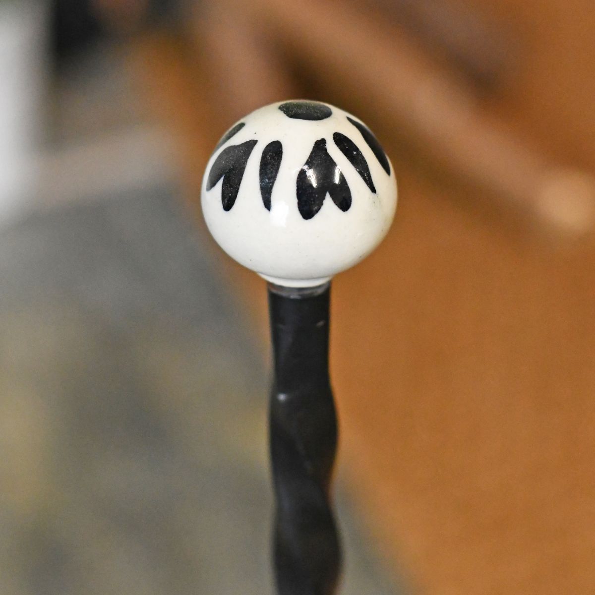 Detailed image of ceramic finial on welly rack