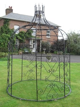 Black Gazebo in front of town house with support bars