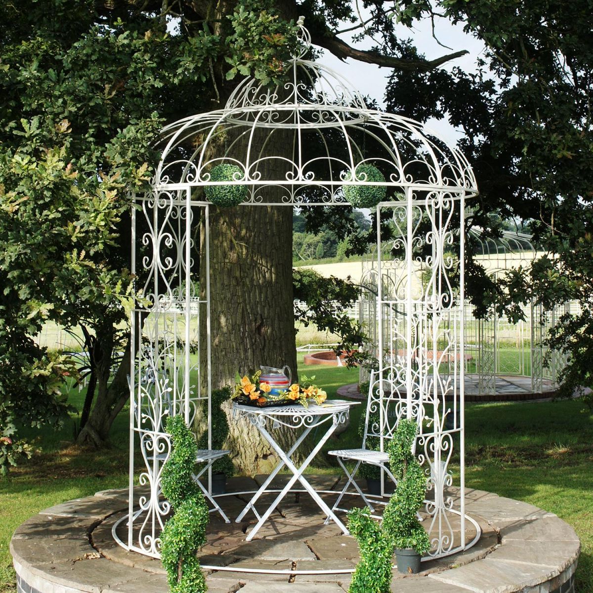 Iron ornate scroll gazebo in garden