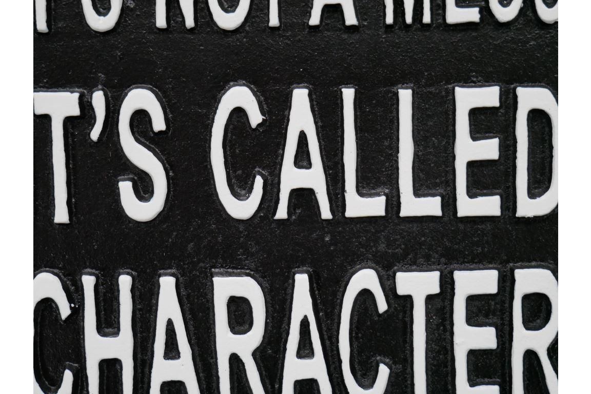 Humorous Interior Iron House Sign in Black Close-Up