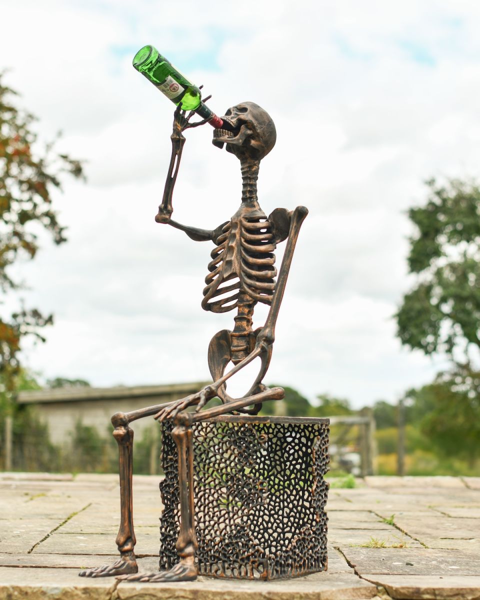 In situ photo of drinking skeleton outdoor statue
