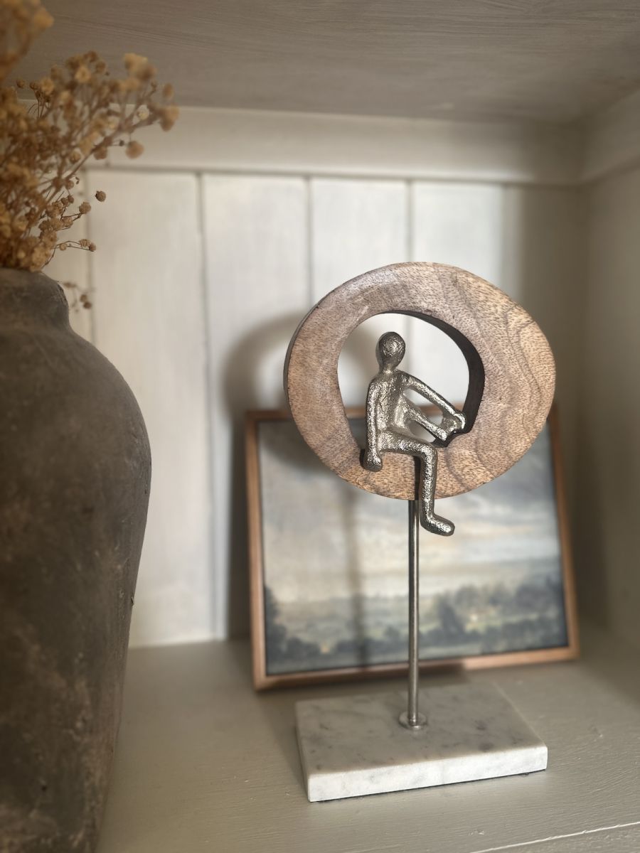 Front view of silver figure on home decor accessory