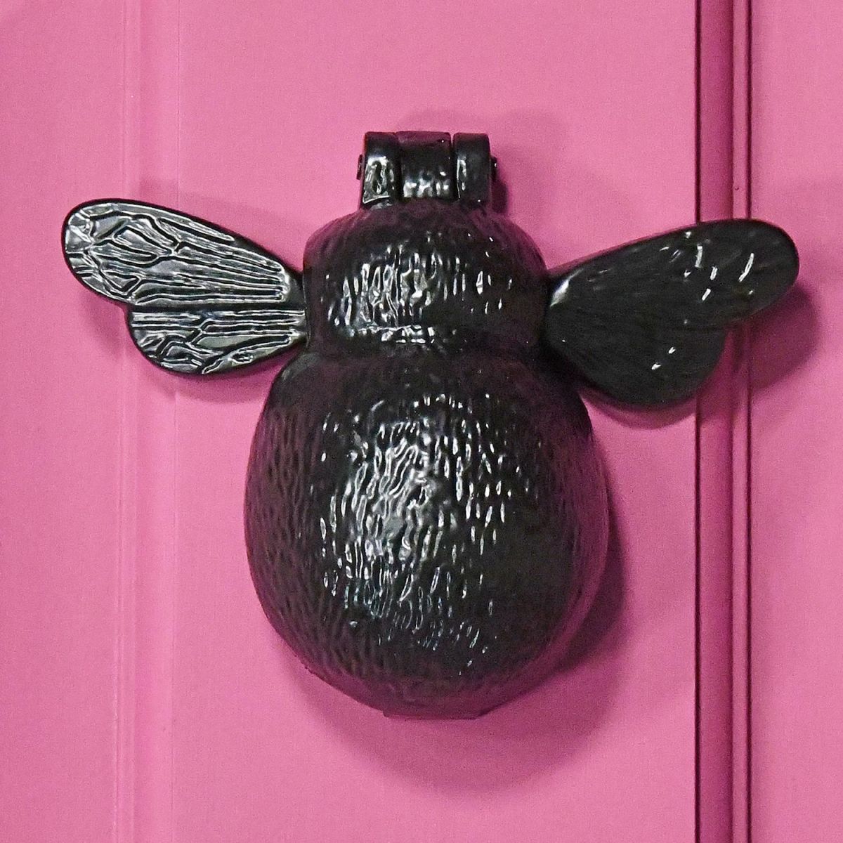 Iron Bumblebee Door Knocker on a Pink Door