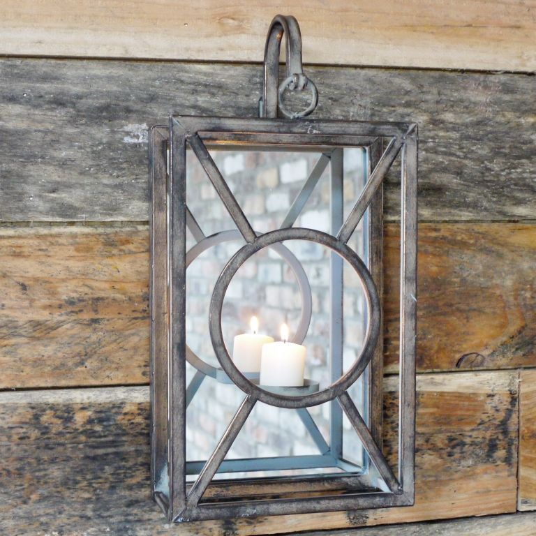 Wall mounted candle holder in natural iron