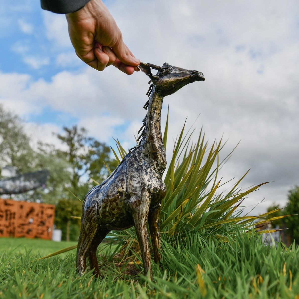 1ft Recycled Metal Standing Giraffe Sculpture with Hand for Scale  1ft Recycled Metal Standing Giraffe Sculpture with Hand for Scale