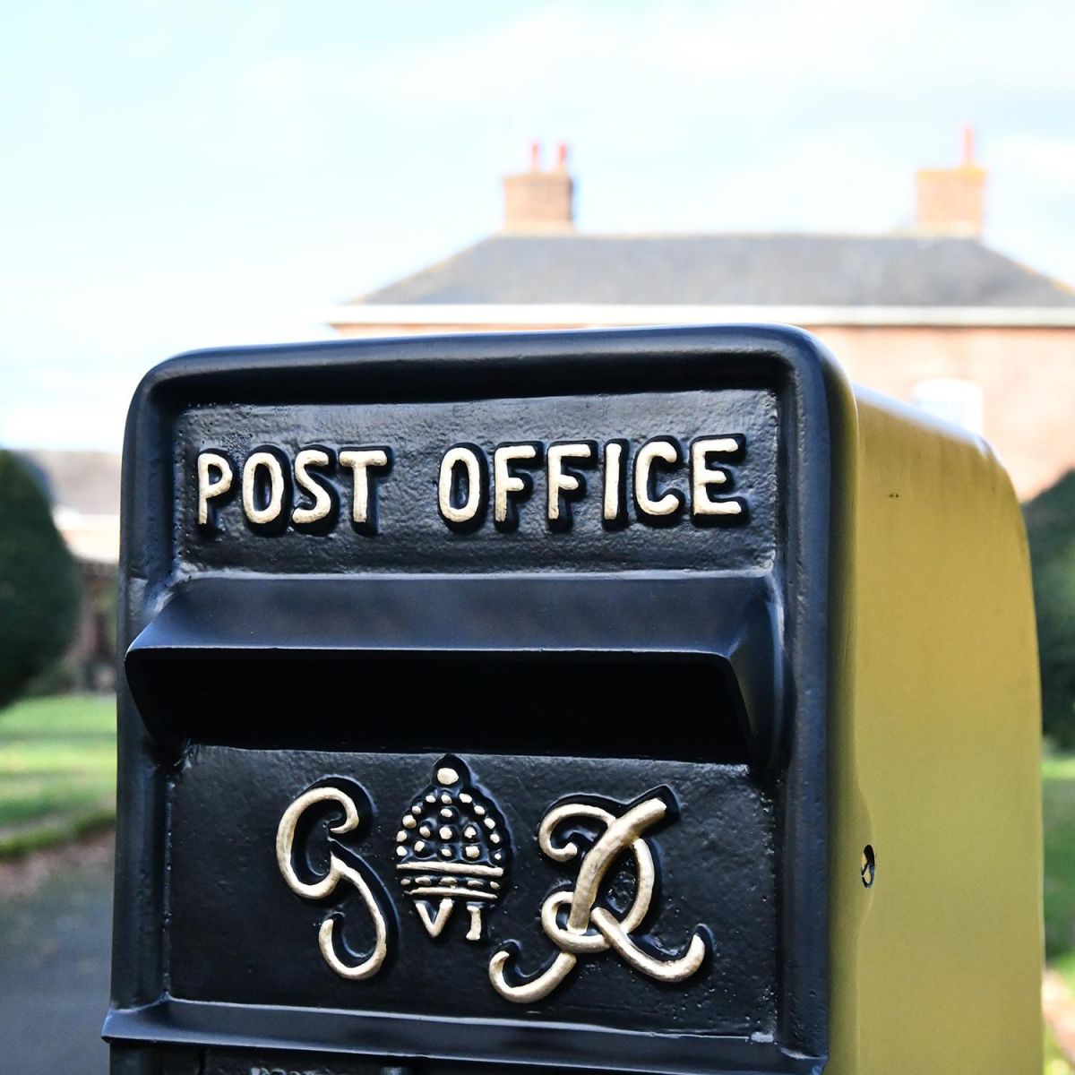 Close-up of the Gold Wording on the King George Rex Black Period Post Box