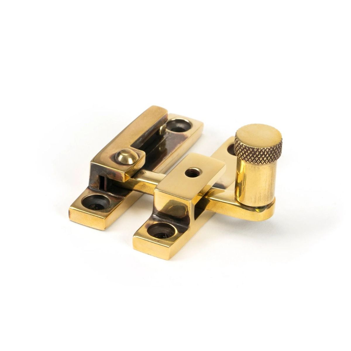 The Knurled Narrow Quadrant Sash Fastener - Aged Brass on a White Background 