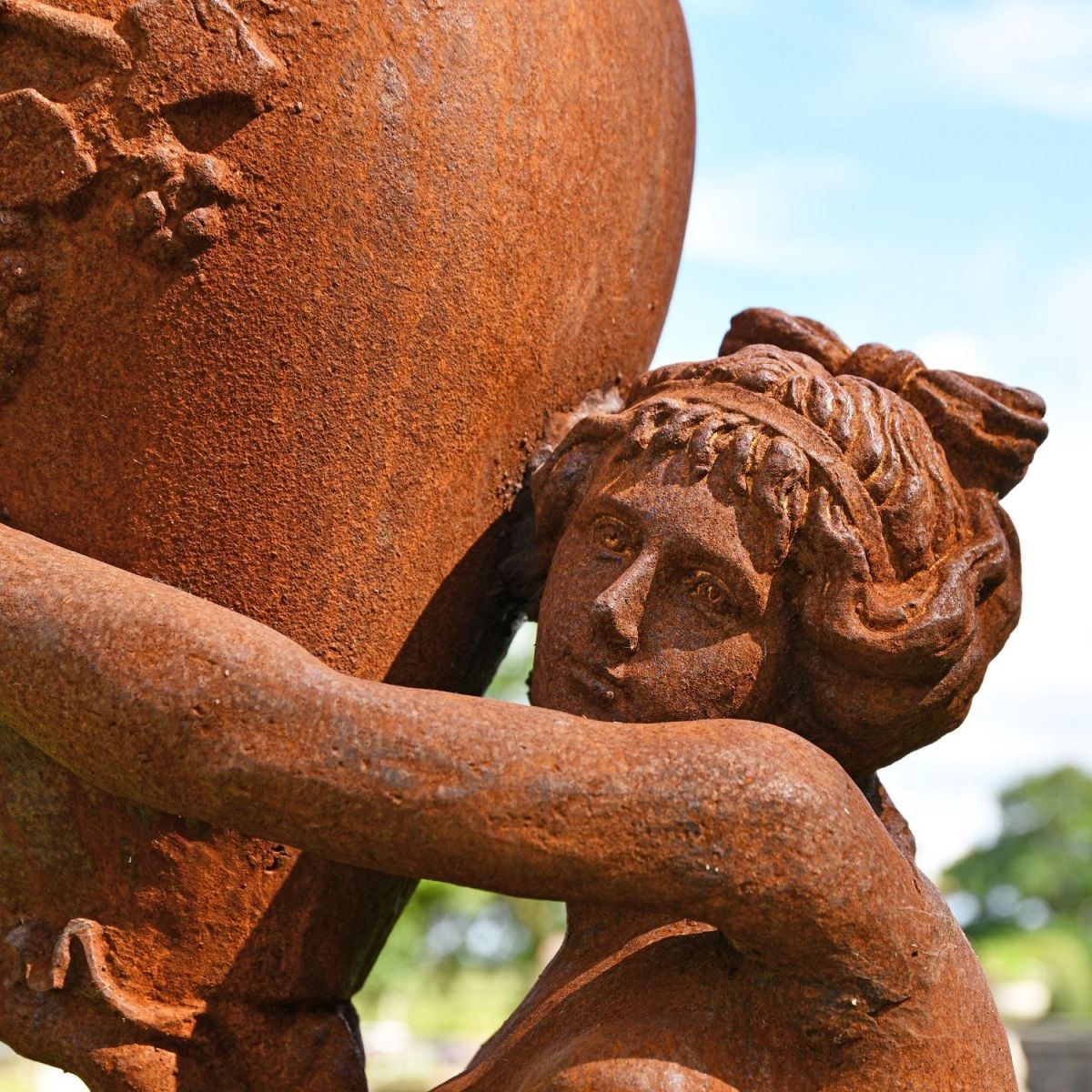 Close up of face on Cast Iron Greek Lady with Vase