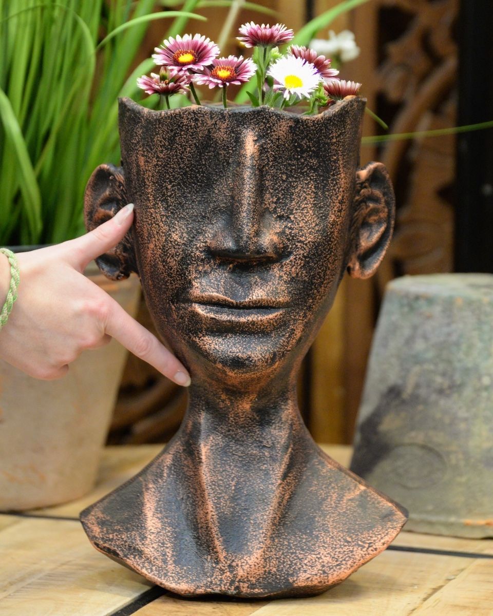 ‘The Watcher’ Contemporary Tribal Planter in Cast Aluminium Large with flowers with hand in shot for scale