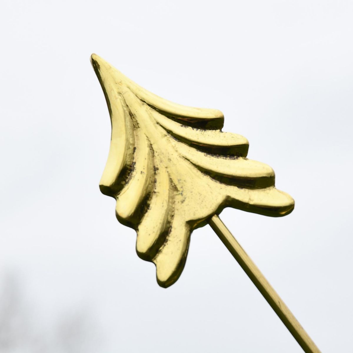Close-up of the Polished Brass Arrow of the Serpent Armillary