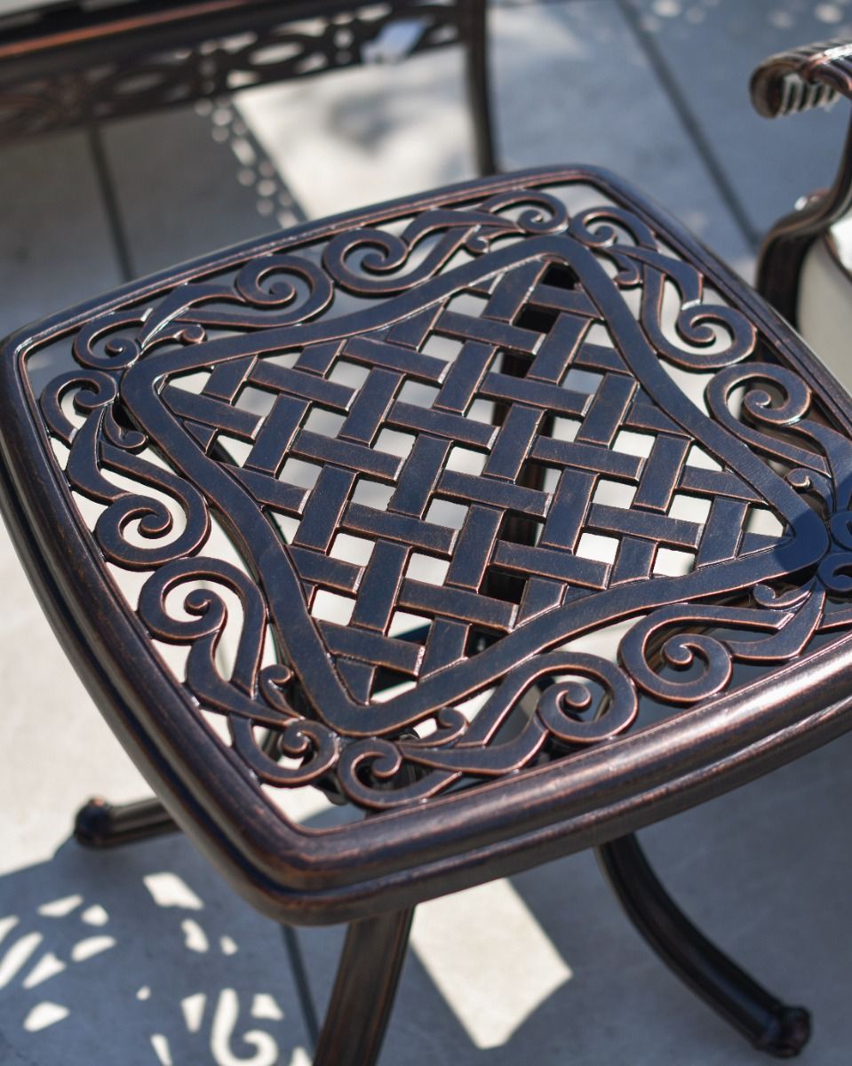 Close up of scrollwork detailing and lattice patternwork on the side table.