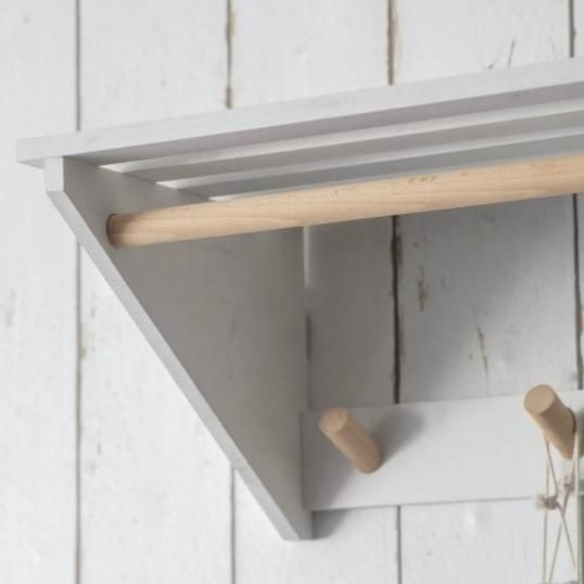 White Slatted Laundry Shelf with Hooks Close Up