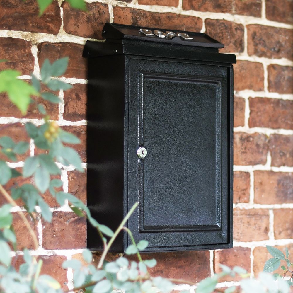 Simplistic post box on house wall Simplistic post box on house wall