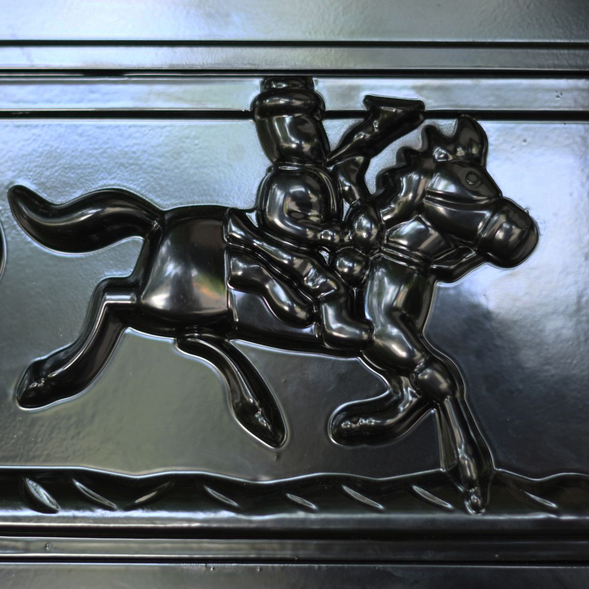 Detailed image of man riding horse on front of letter box door