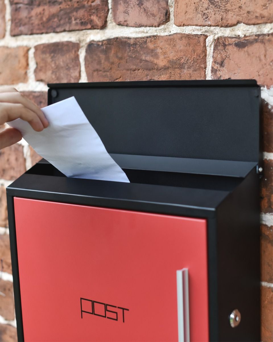 Posting a letter in contemporary box Posting a letter in contemporary box