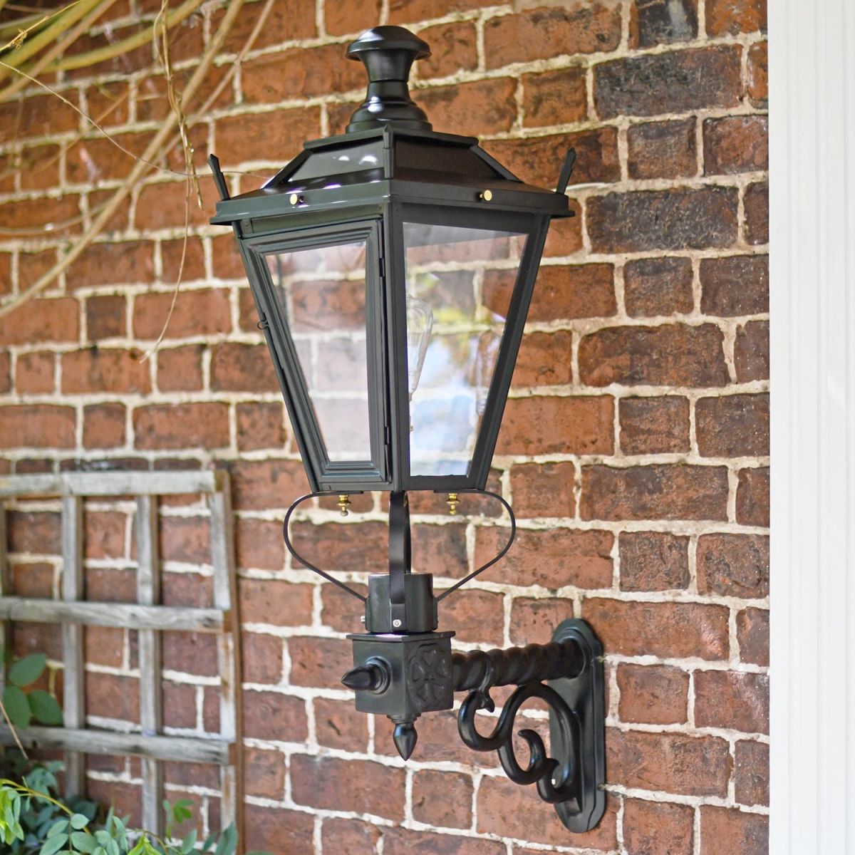 Black Dorchester garden lantern on brick wall