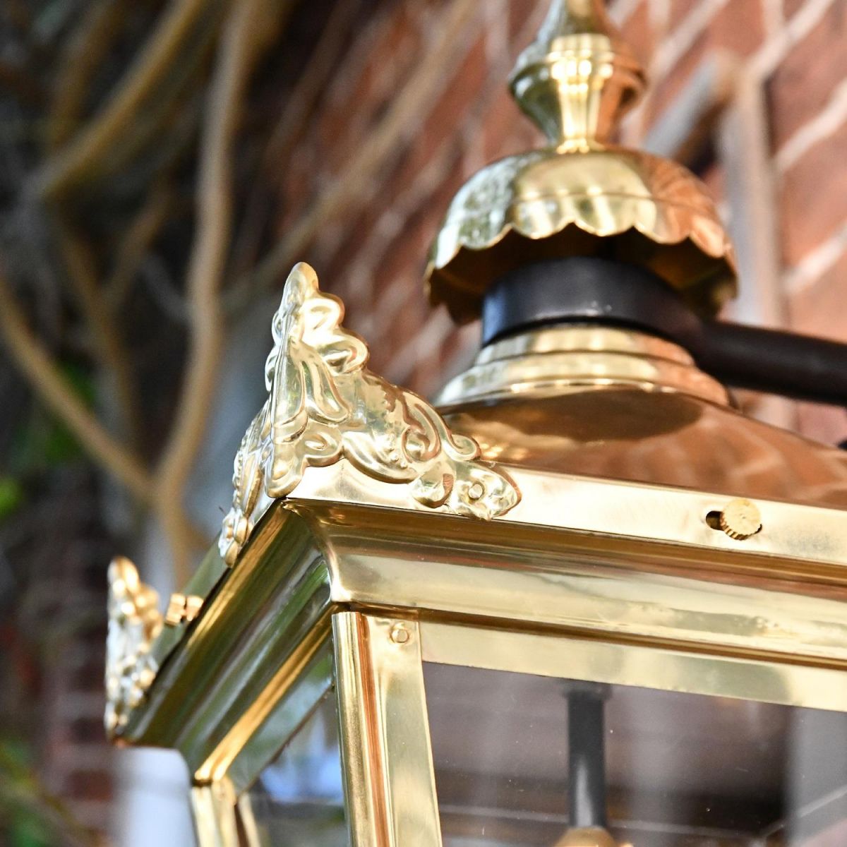 Close up of decorative finials on wall lantern corners 