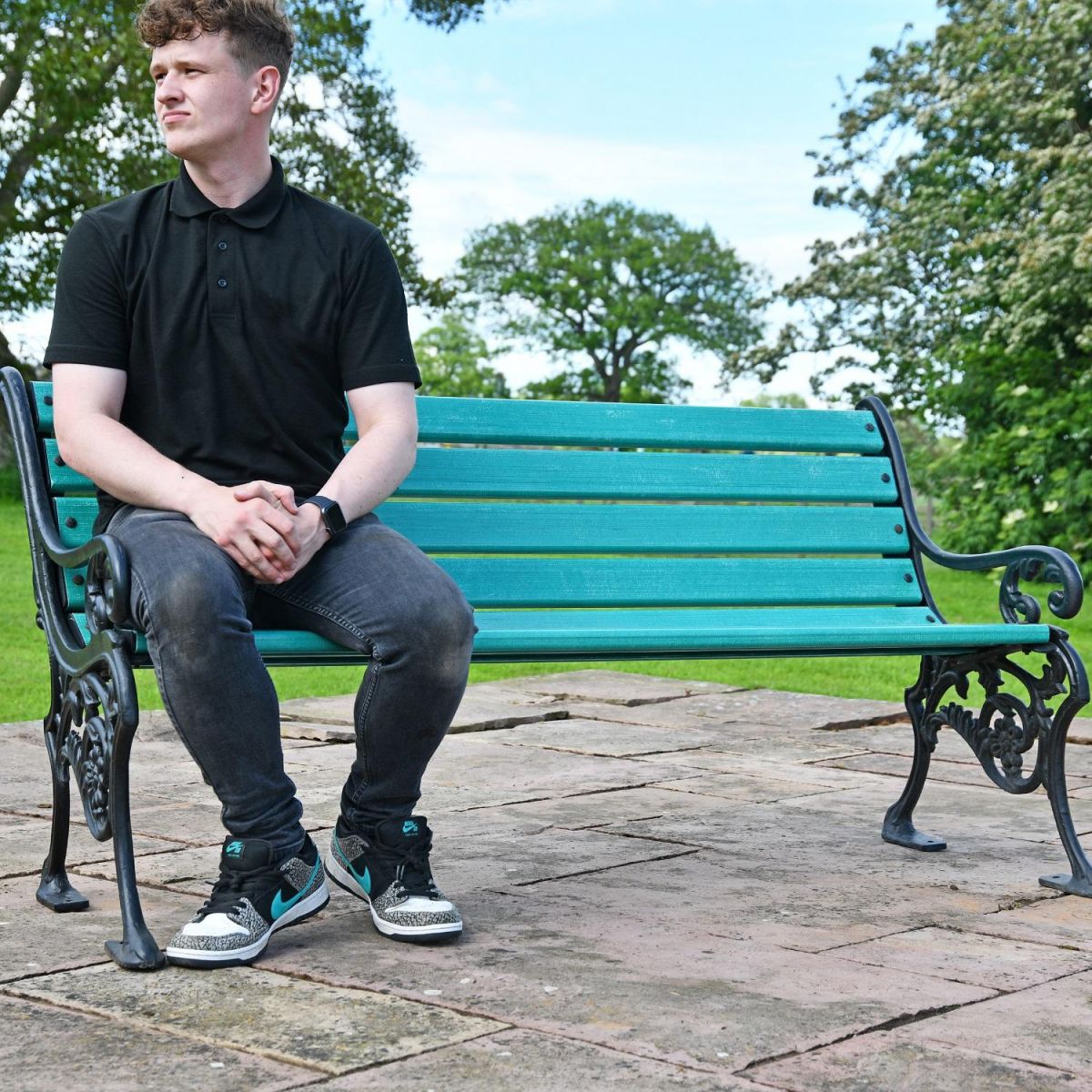Male sat on bench for scale 