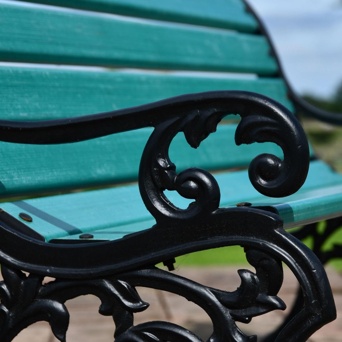 Close up of filigree detailing on cast iron arm rest 