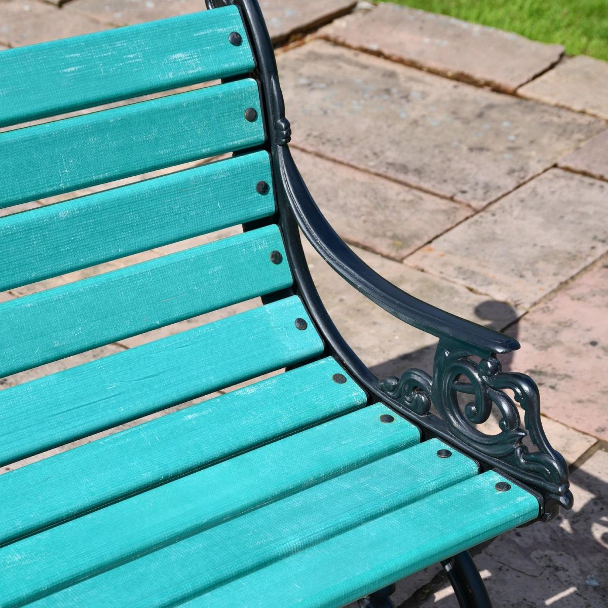 Close up of "green" slats and cast iron arm rest  Close up of "green" slats and cast iron arm rest