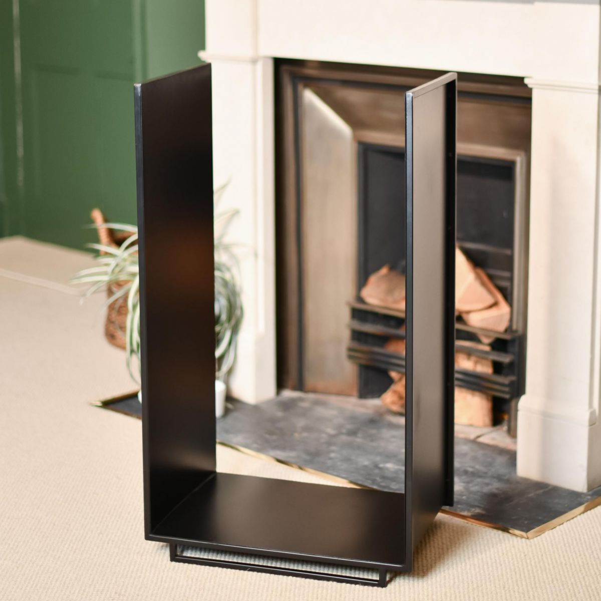 Long Black Contemporary Log Rack in Front of the Fire Place