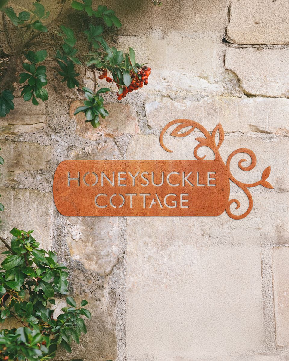 "Lovestone" Corten Steel House Name Sign on a Rustic Wall