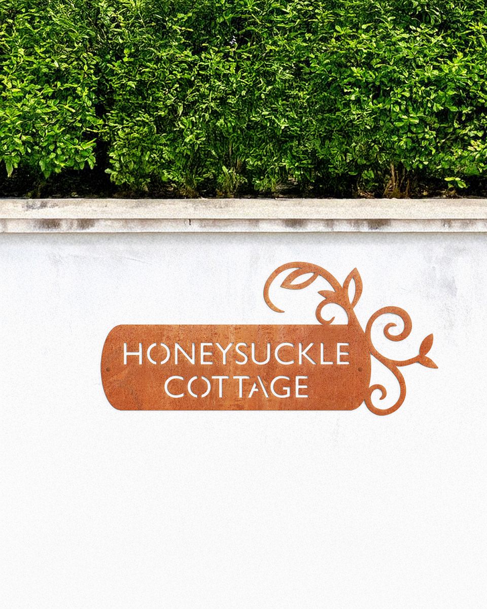 Corten Steel House Name Sign in situ on a White Garden Wall