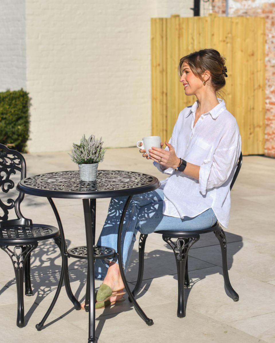 Lifestyle Shot Of The Aged Black Brooksby Garden Furniture Set Lifestyle Shot Of The Aged Black Brooksby Garden Furniture Set