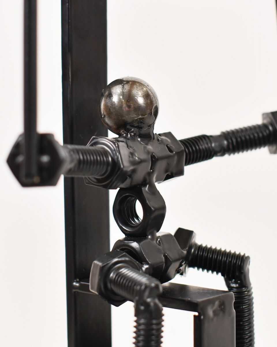 Close up of intricate person detailing on scrap metal art sculpture