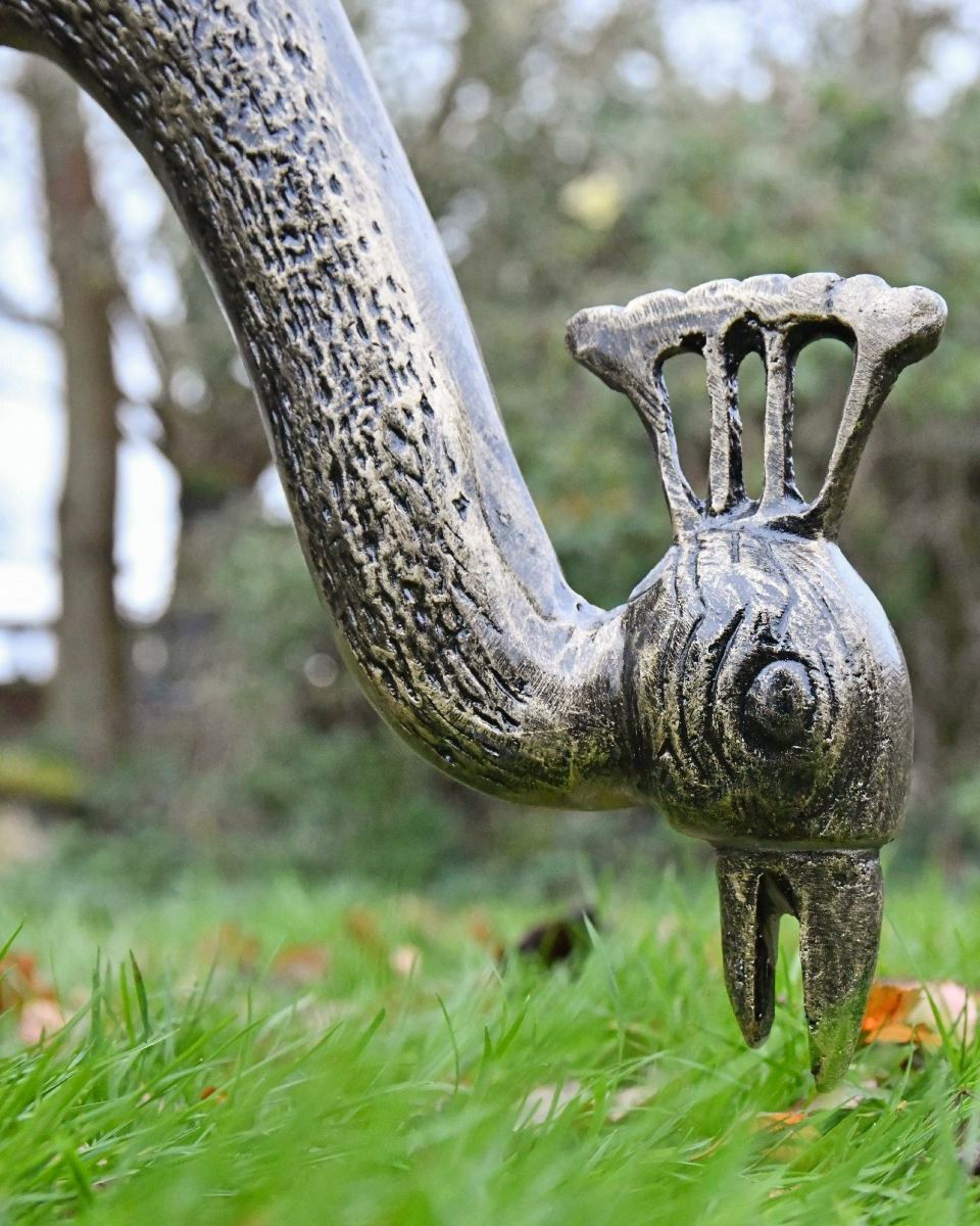 Close-up of the Majestic Peacock Sculpture Eating Grass in the Garden