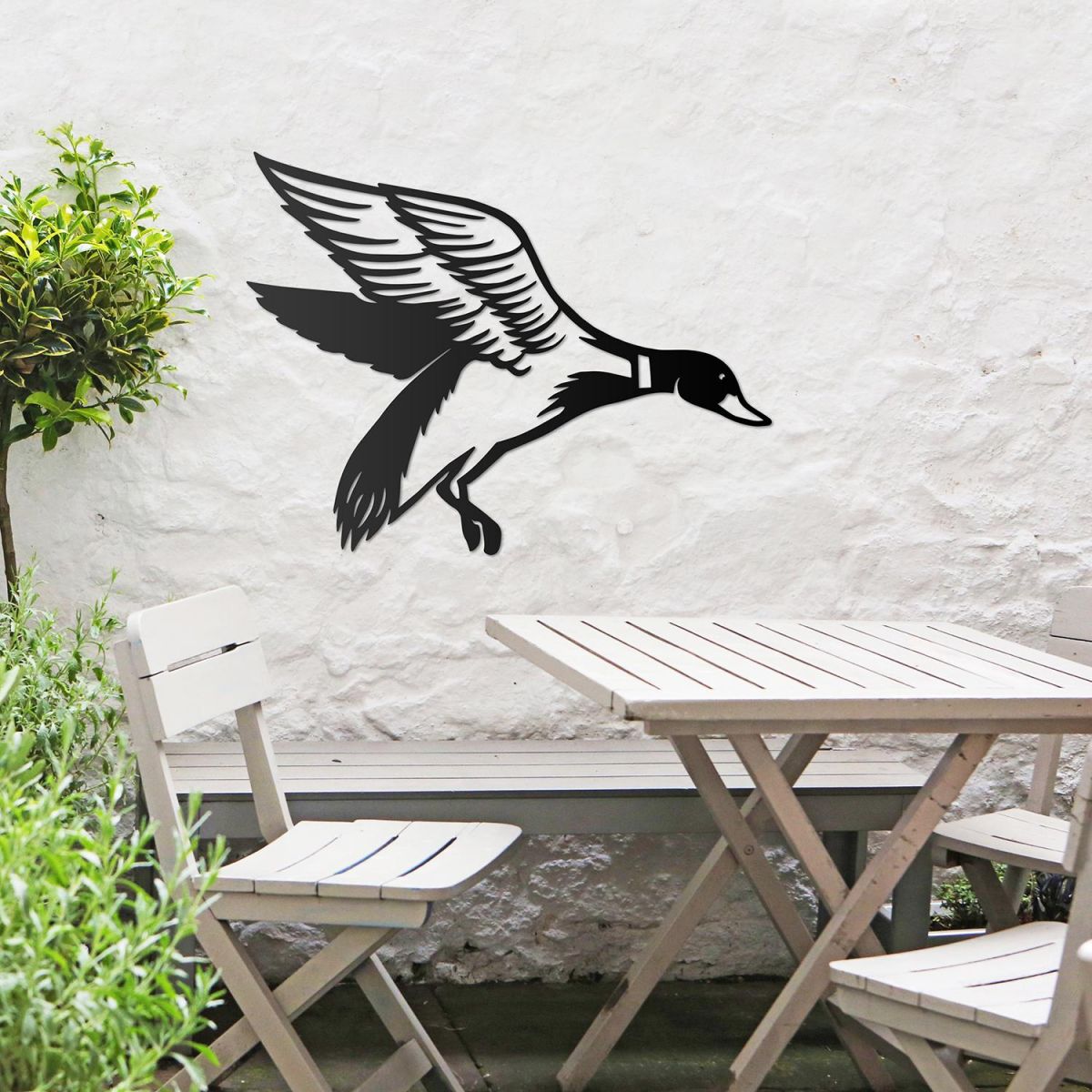 "Mallard" Duck Wall Art in the Garden Above a Wooden Table and Chair Set "Mallard" Duck Wall Art in the Garden Above a Wooden Table and Chair Set