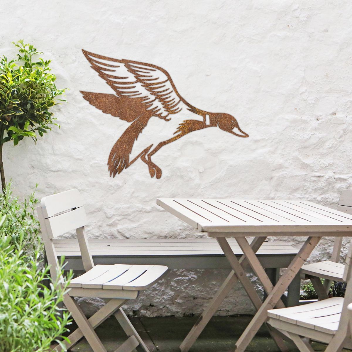"Mallard" Duck Wall Art in the Garden Above a Wooden Table and Chair Set