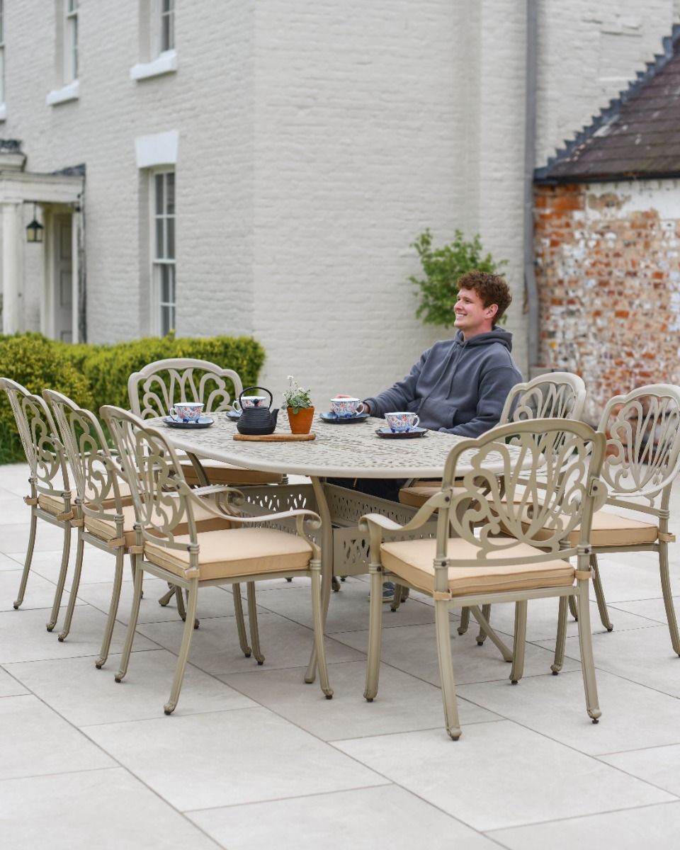 Man Sat at Large Oval Garden Table Man Sat at Large Oval Garden Table