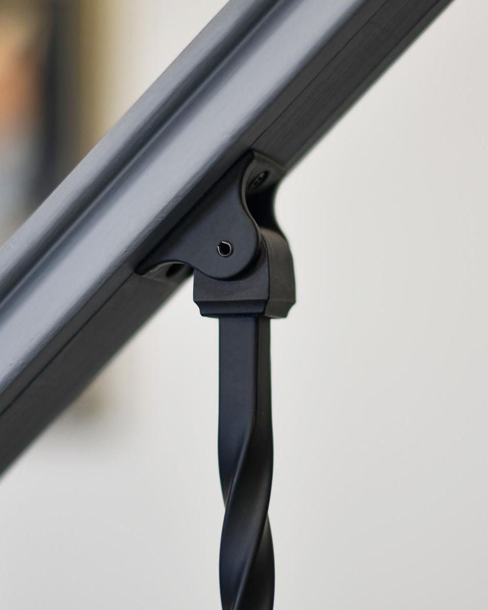 Close-up of the Adjustable Stair Spindle Bracket Attached to the Handrail