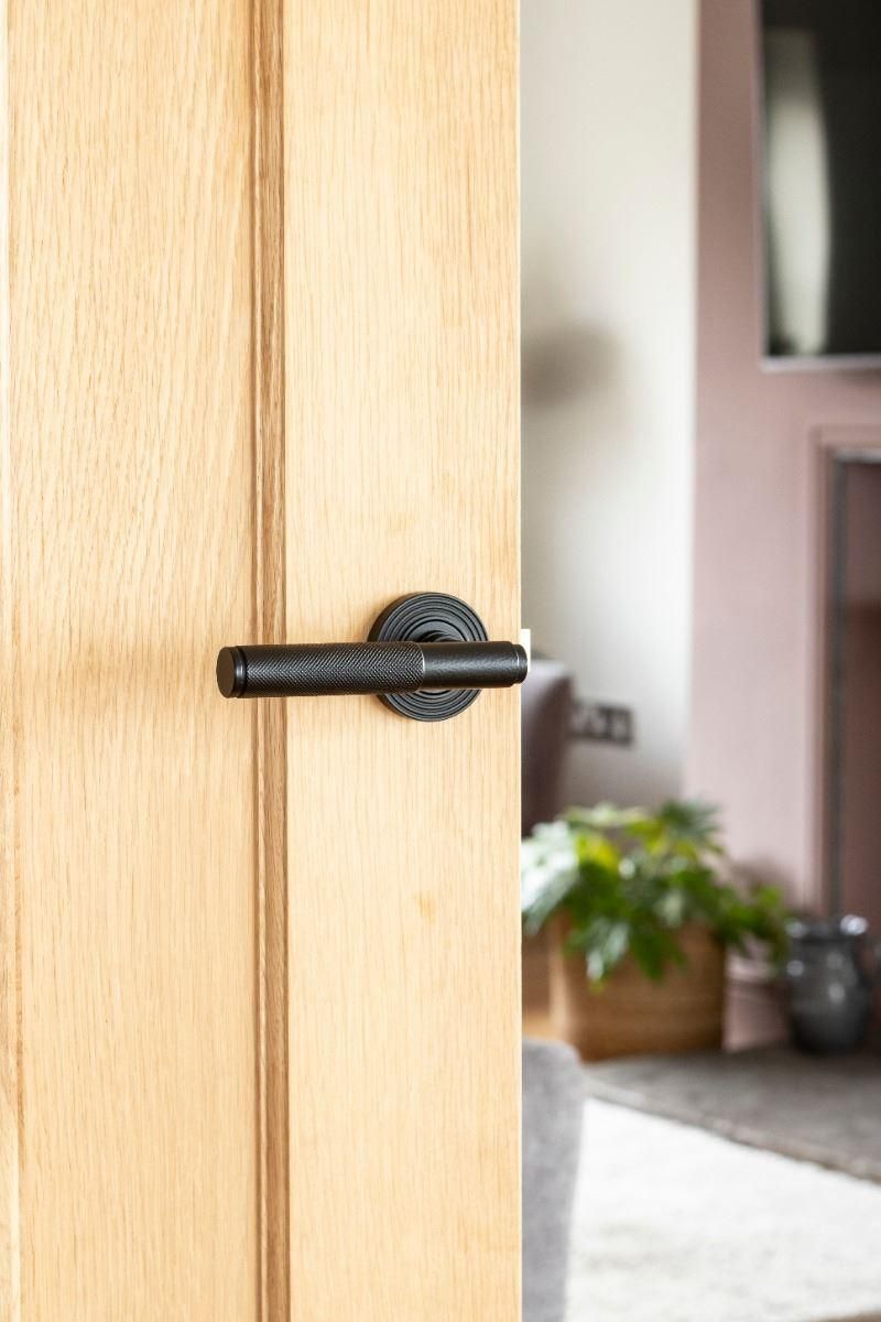 Matte Black Textured Lever Door Handle on Beehive Rose on Door Matte Black Textured Lever Door Handle on Beehive Rose on Door