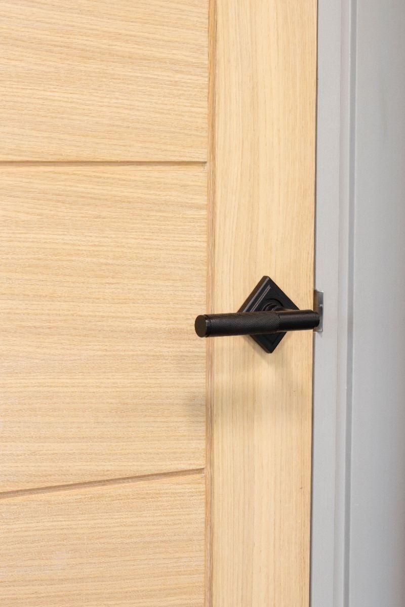 Matte Black Textured Unsprung Lever Door Handle on Diamond Rose on Door