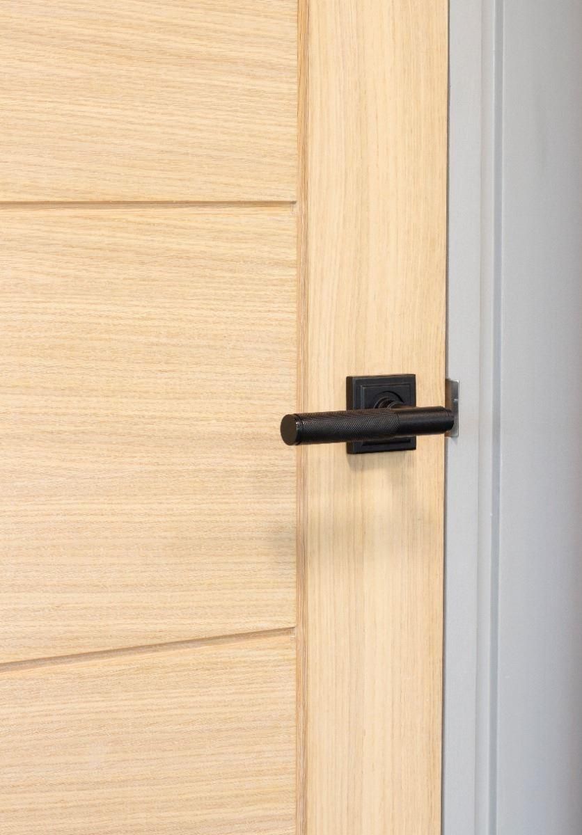 Matte Black Textured Unsprung Lever Door Handle on Square Rose on Door