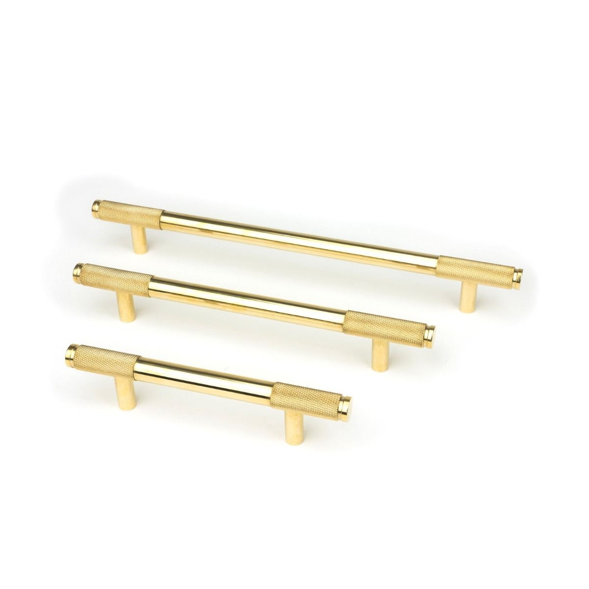The Small Knurled Cabinet Pull Handle in Aged Brass Alongside Different Sizes on a White Background