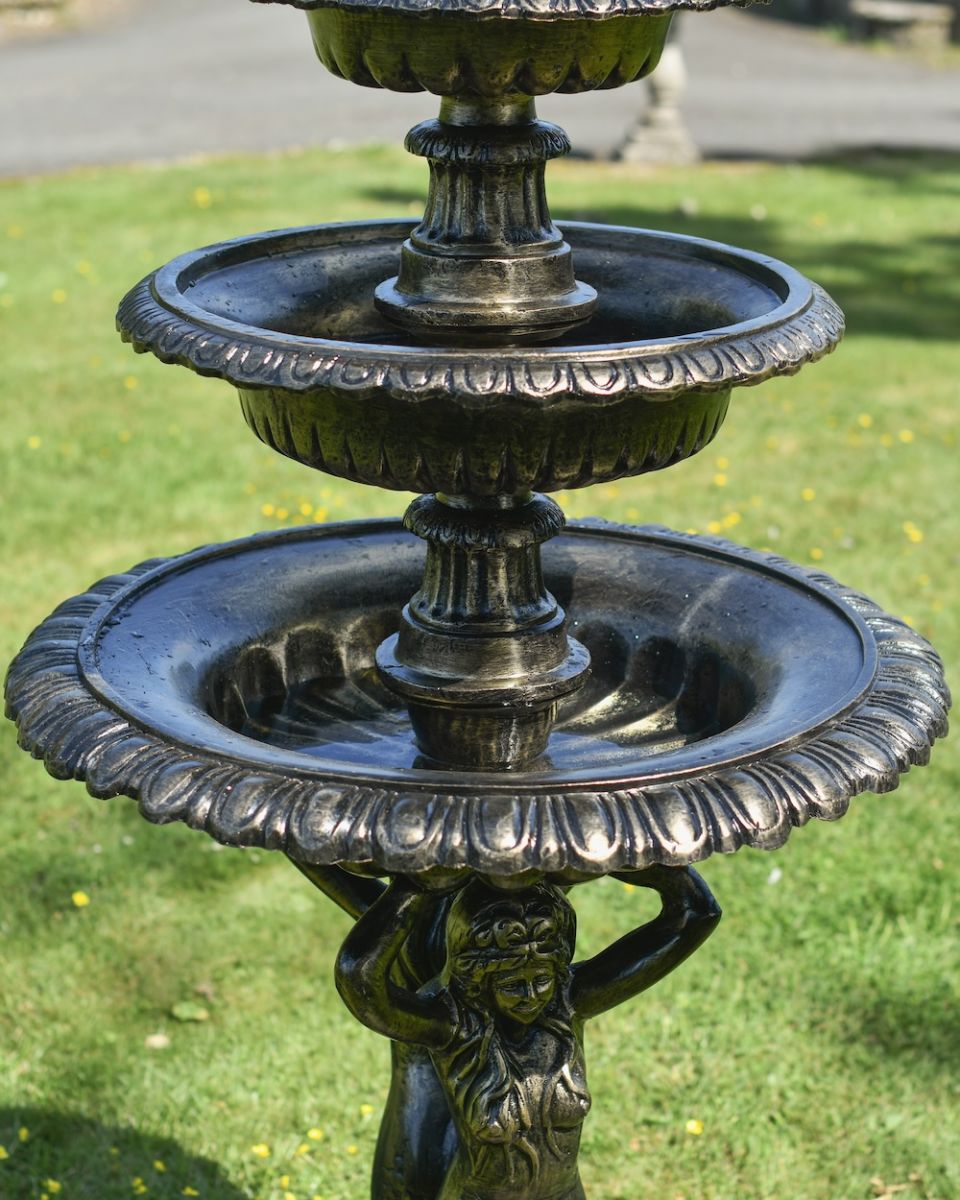 Close up of ornate detail on mermaid water fountain Close up of ornate detail on mermaid water fountain