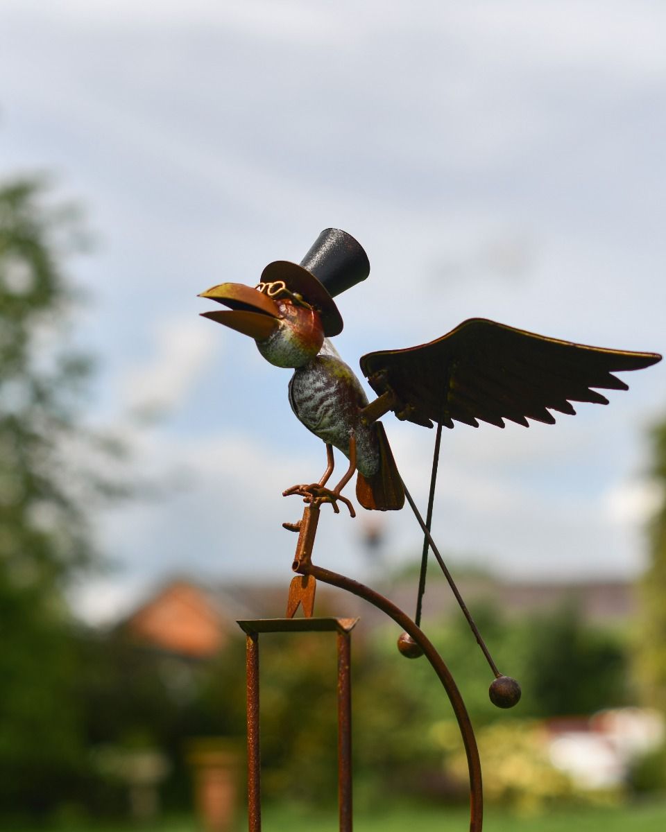 Close Up of Hand-Painted Metal Bird on Spike 